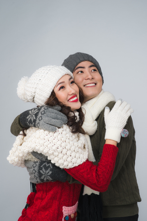 Happy young hipster couple hugging. Cold season. Romantic mood.の写真素材