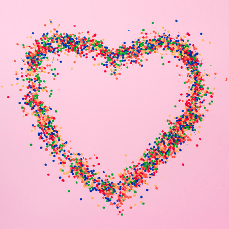 Valentines Day background. Heart shape with candies on pink.の写真素材