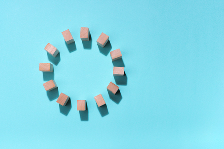 Wooden block in circle on blue background.の写真素材