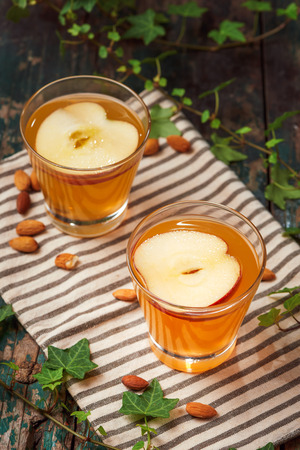 Hot drink of apple tea with cinnamon stick. Hot drink with apples for autumn or winter.の写真素材