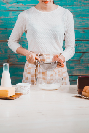 House wife wearing apron making. Steps of making cooking chocolate cake.の写真素材