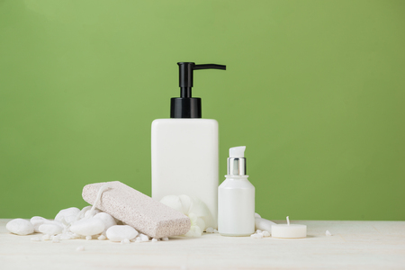 SPA Decoration. Spa composition with cosmetic bottle over green.の写真素材
