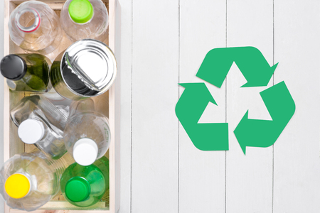 Eco concept. Waste recycling symbol with garbage on stoneの写真素材