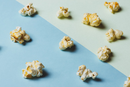 The popcorn in paper cup on green and blue background.の写真素材
