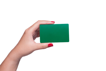 Female hand holding blank green card isolated on white background.の写真素材