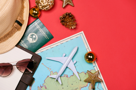 Preparation for travel concept - Toy plane, camera, cup of tea, clothes on wooden background.の写真素材