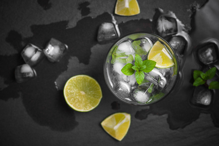 Mojito cocktail with lime and mint in glass on a grey stone backgroundの写真素材