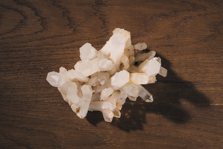 Natural white stones on wooden background. Top view.