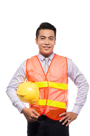 Young engineer with yellow helmet is isolated on white background.の写真素材