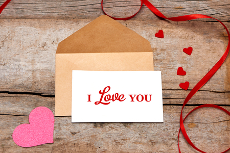 Love letter valentine rose and in envelope on wooden backgroundの写真素材