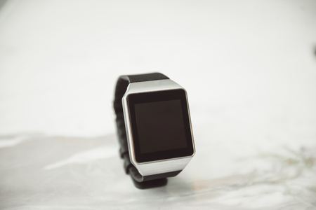 Unknown smart wrist watch laying on the tableの写真素材