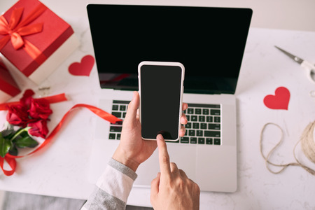 Man is shopping through the Internet using smartphone with blank screen.の写真素材
