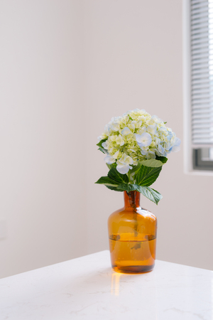 Beautiful spring flowers in vase on window background.の写真素材