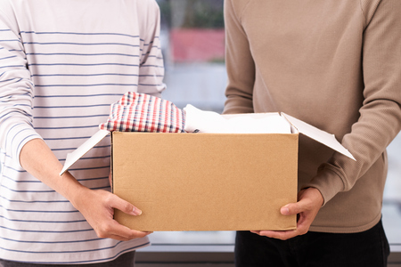 Man holding a clothes donate box. Donation concept.の写真素材