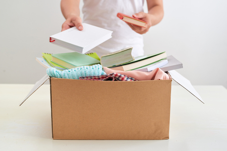 Man holding a book donate box. Donation concept.の写真素材