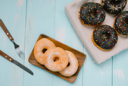 Overhead view of chocolate cake donuts with salted caramel glaze with a cup of espresso on marble table top. Afternoon me time book reading with dessert and coffee. Text space imagesの写真素材