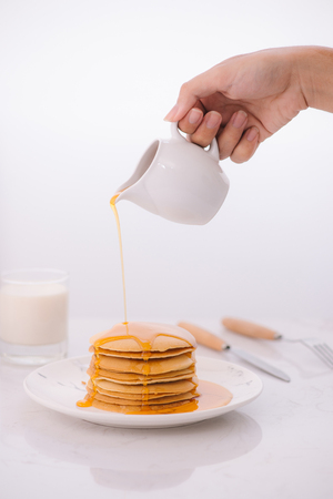 Pancakes for breakfast with honey and milk.の写真素材