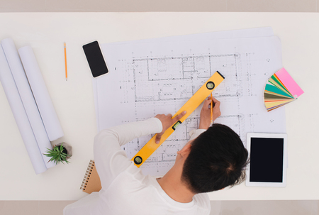Top view of male architect drawing on architectural projectの写真素材