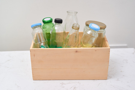 Empty bottles in wooden container on table.の写真素材