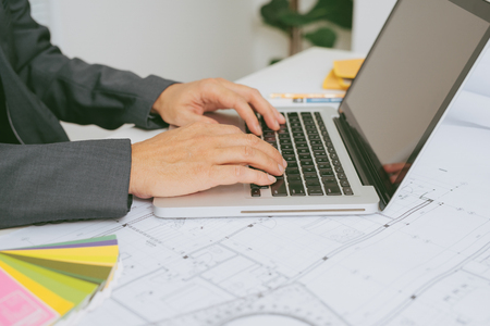 Professional construction manager working with blue print in officeの写真素材