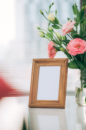 A greeting card template with a place for text, a photo of a blank frame in a bouquet of lisianthus flowersの写真素材