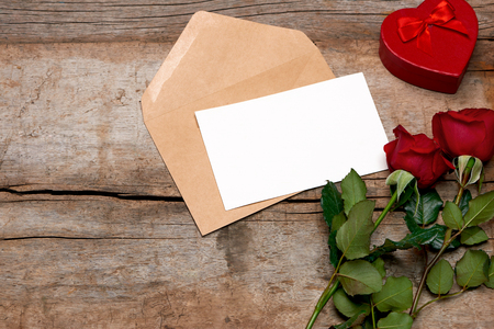 Love letter valentine rose and in envelope on wooden backgroundの写真素材