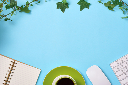 Top view of desk with smartphone, coffee cup, passport, plane model and credit card.の写真素材