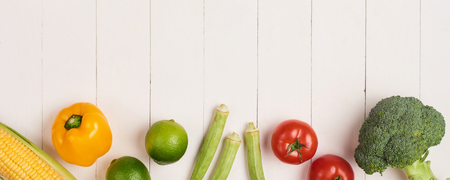 Heap of fresh fruits and vegetables on wooden backgroundの写真素材