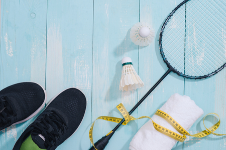 Top view of sport equipments, clock, tape measure, shoes, water bottle, towel, badminton racket and shuttlecock, Healthy lifestyle and fitness conceptの写真素材