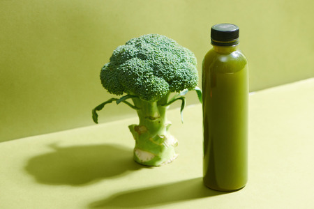 Bottle of the fresh broccoli juice on table. Healthy drink.の写真素材