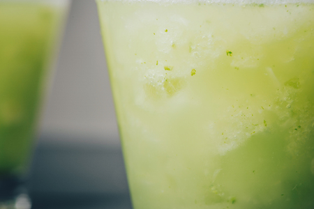 Cocktail juice with lime, mint and ice. Bar drink accessories on black table background.の写真素材
