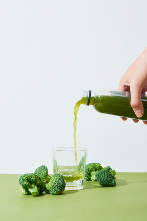 Bottle of the fresh broccoli juice on table. Healthy drink.の写真素材