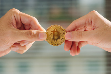 uncertainty with bitcoin in hand,war of bitcoin,pull bitcoin with hand to hand, many bitcoins up,on...