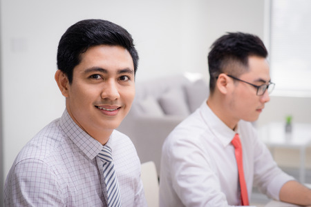 two business men working at pc in office