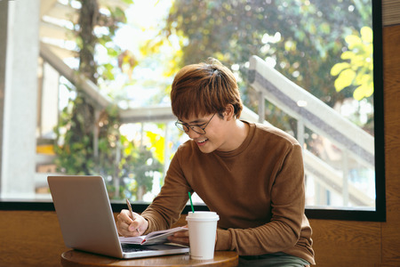 Man is doing his freelance job early in the morning.の写真素材