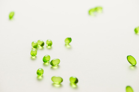 Top view many gel capsules on white background isolated. Vitamin E 200 mg capsules.の写真素材