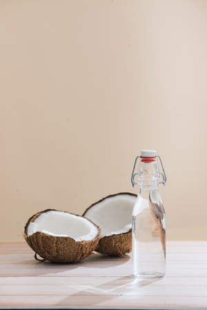 Healthy skincare. Pure coconut oil is made from organic coconut on wooden backgroundの写真素材