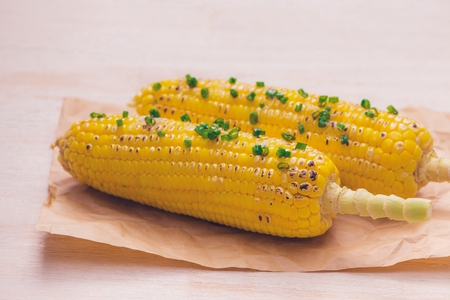 Delicious tasty grilled corn on wooden tableの写真素材