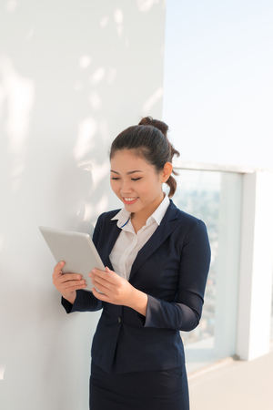 Portrait of smiling business woman using tablet pcの写真素材