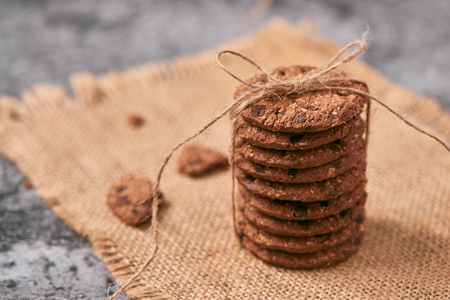freshly baked chocolate chip cookies on stone tableの写真素材