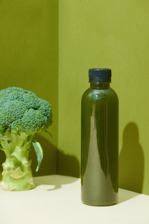 Bottle of the fresh broccoli juice on table. Healthy drink.の写真素材