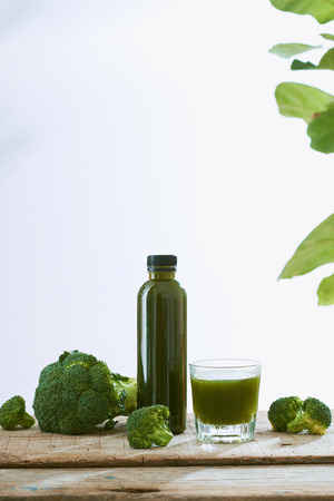 Bottle of the fresh broccoli juice on table. Healthy drink.の写真素材