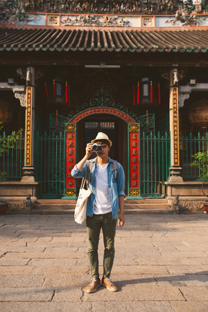 Young traveler taking pictures of the ancient city in asia styleの写真素材