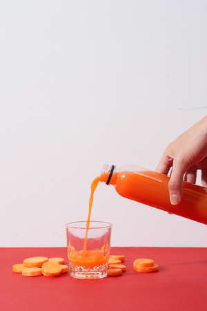 Fresh natural carrot juice on table. Healthy drink.の写真素材