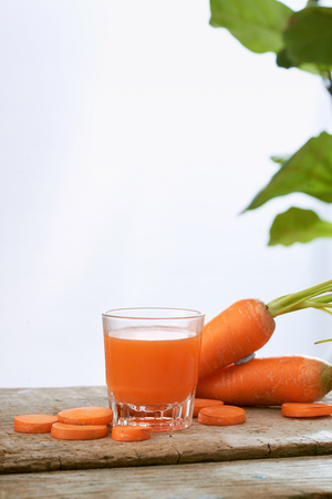 Fresh natural carrot juice on table. Healthy drink.の写真素材