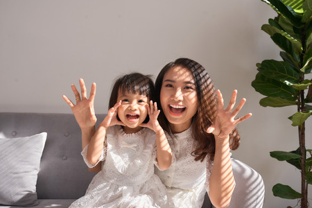 Happy young mother with daughter at home