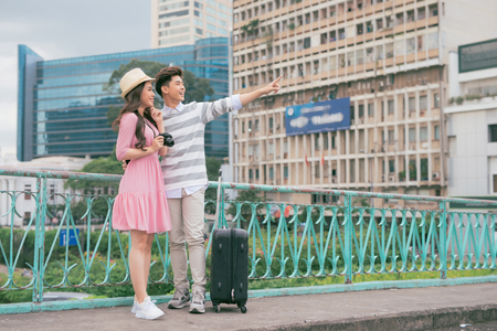 Young lovers walking around city on vacation, enjoying traveling together, outdoors.の写真素材