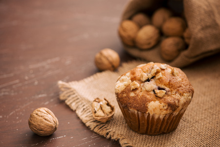 Tasty homemade walnut muffins on table. Sweet pastriesの写真素材