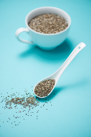 Cup of healthy chia seeds and spoon. Text space.の写真素材