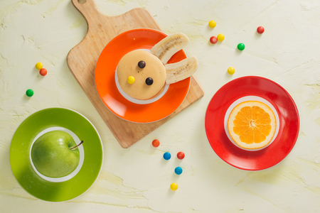 Funny bunny pancakes with fruits for Easter kids breakfastの写真素材